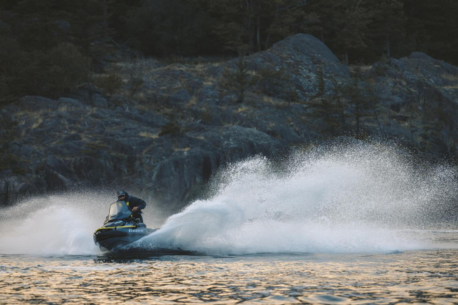 A rider navigates a jet ski on the water, showcasing excitement and adventure against a backdrop of waves. A rider navigates a jet ski on the water, showcasing excitement and adventure against a backdrop of waves.